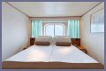 An old Holland America cruise ship is turning residential, letting travelers live at sea for $8,000 a month while it circumnavigates the globe